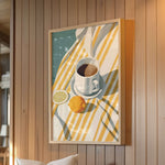 a framed painting of a cup of coffee and a lemon on a table, hanging on a wooden wall.