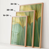 three framed prints of a leafy green plant, each with a different size and frame. The prints are arranged in a row, with the largest print on the left, the medium-sized print in the middle, and the smallest print on the right. The prints are displayed on a white wall, and there are arrows pointing to the size of each print.
