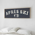 a bedroom with a bed and a framed sign that reads "APRES SKI" above it.