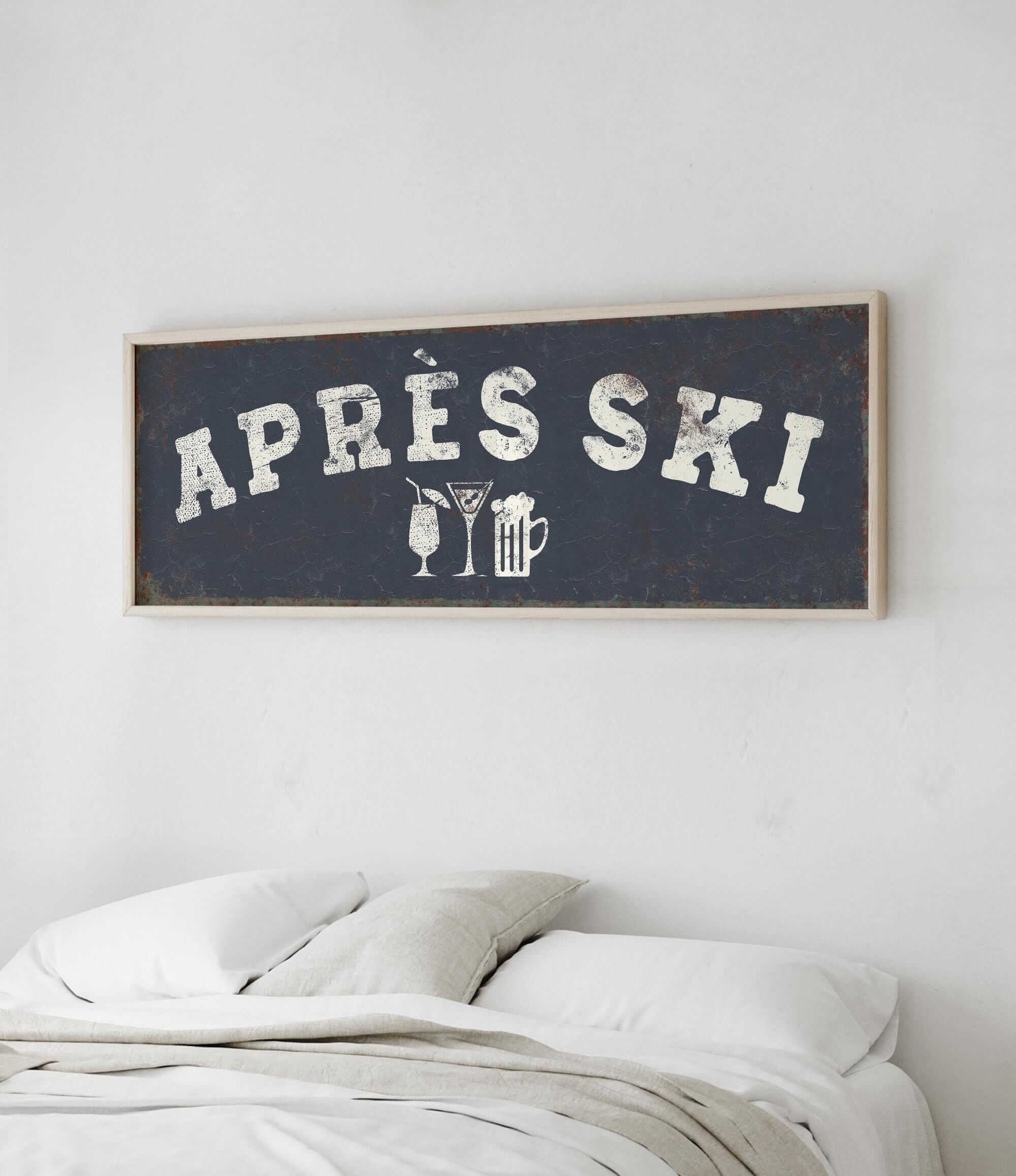 a bedroom with a bed and a framed sign that reads "APRES SKI" above it.