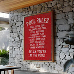 a red sign on a stone wall next to a table