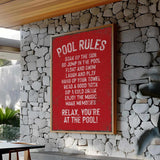 a red sign on a stone wall next to a table