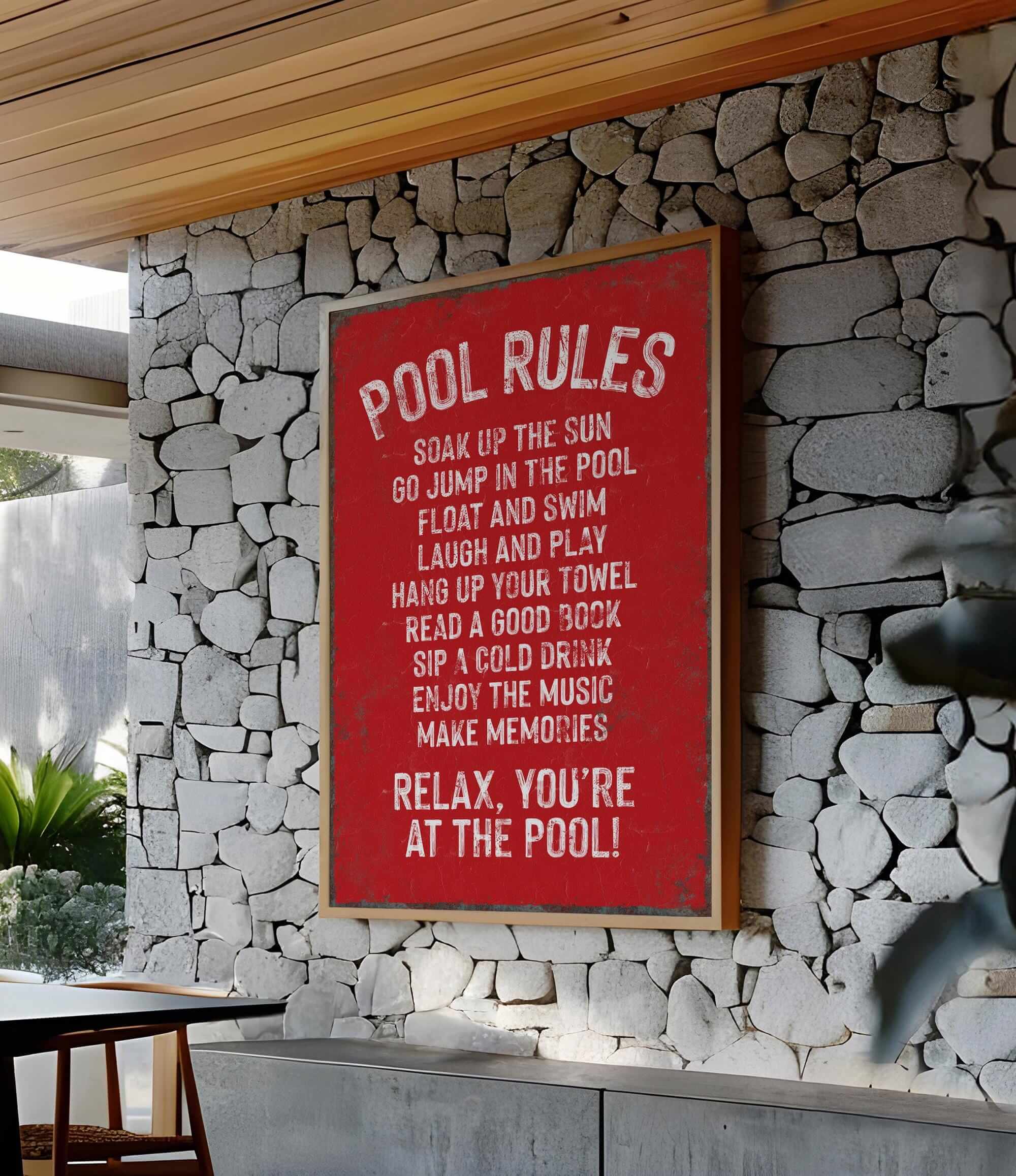 a red sign on a stone wall next to a table