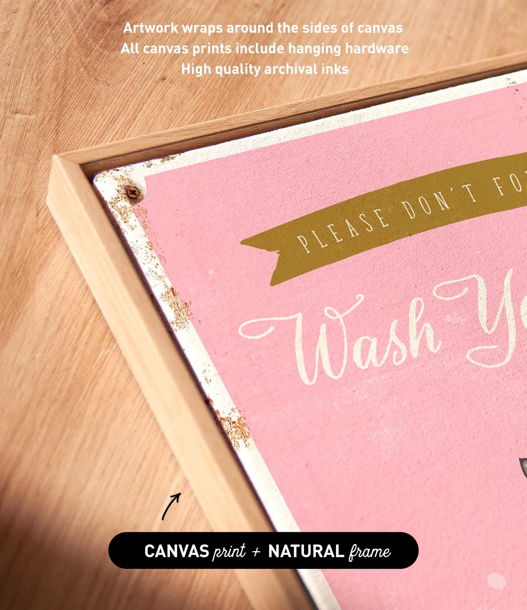 a pink canvas with the text "Please don't wash" written on it, along with a gold ribbon. The text is in a cursive font and is framed by a wooden border. The image also includes a caption that reads "Artwork wraps around the sides of canvas All canvas prints include hanging hardware High quality archival inks".