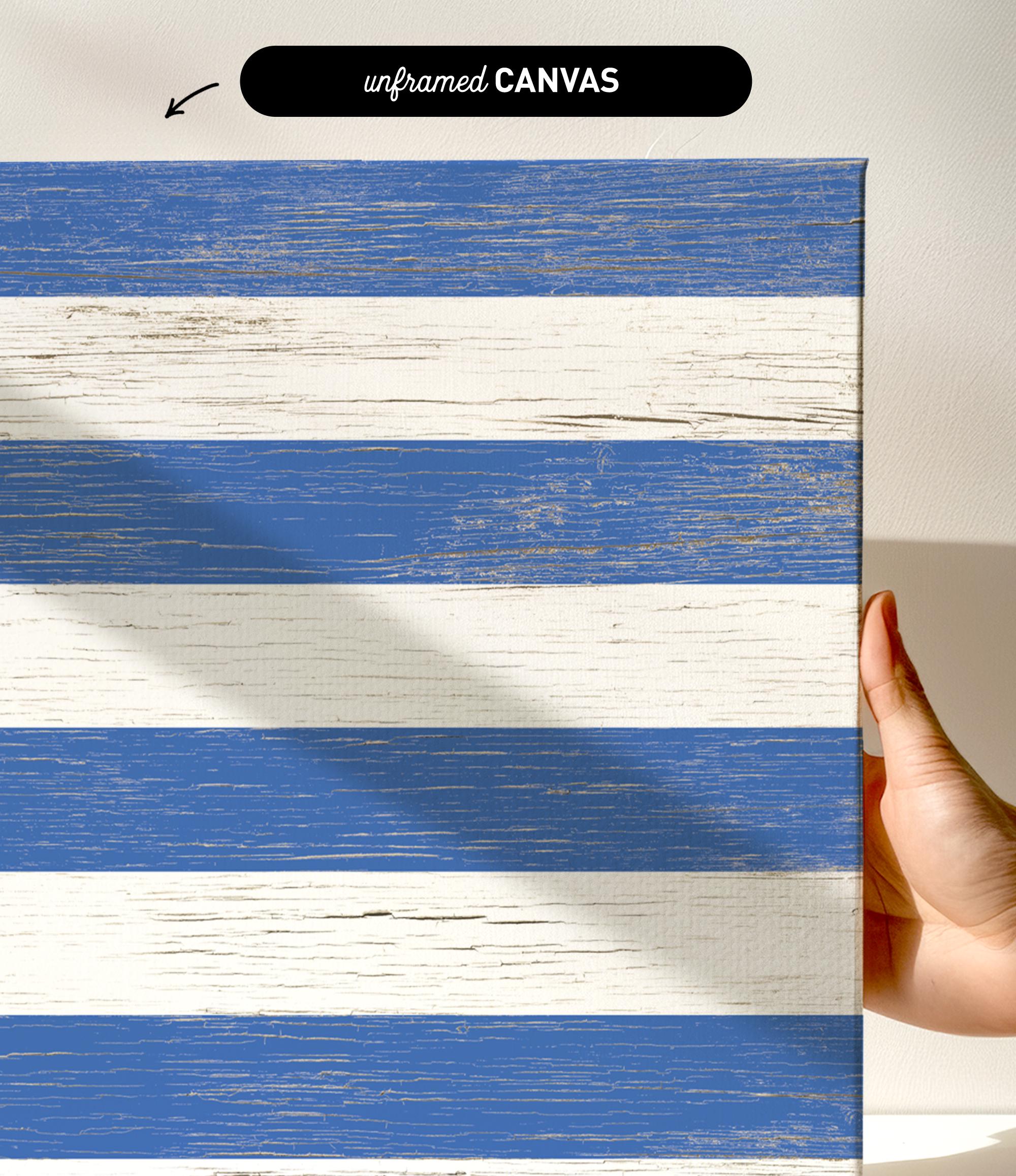 a hand holding a piece of wood with a blue and white stripe painted on it