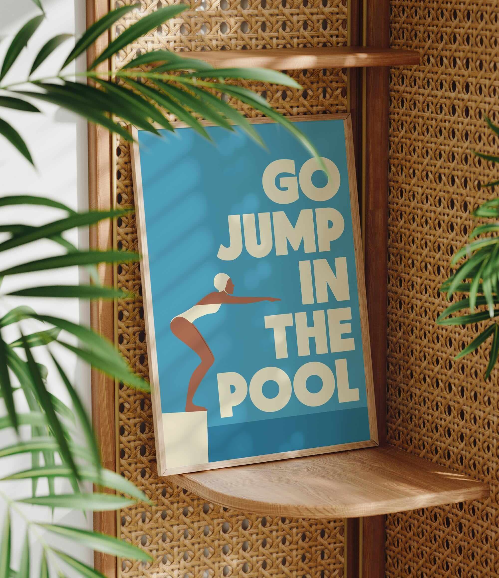 A poster with the text "GO JUMP IN THE POOL" is displayed on a wooden shelf, with a plant visible in the foreground.