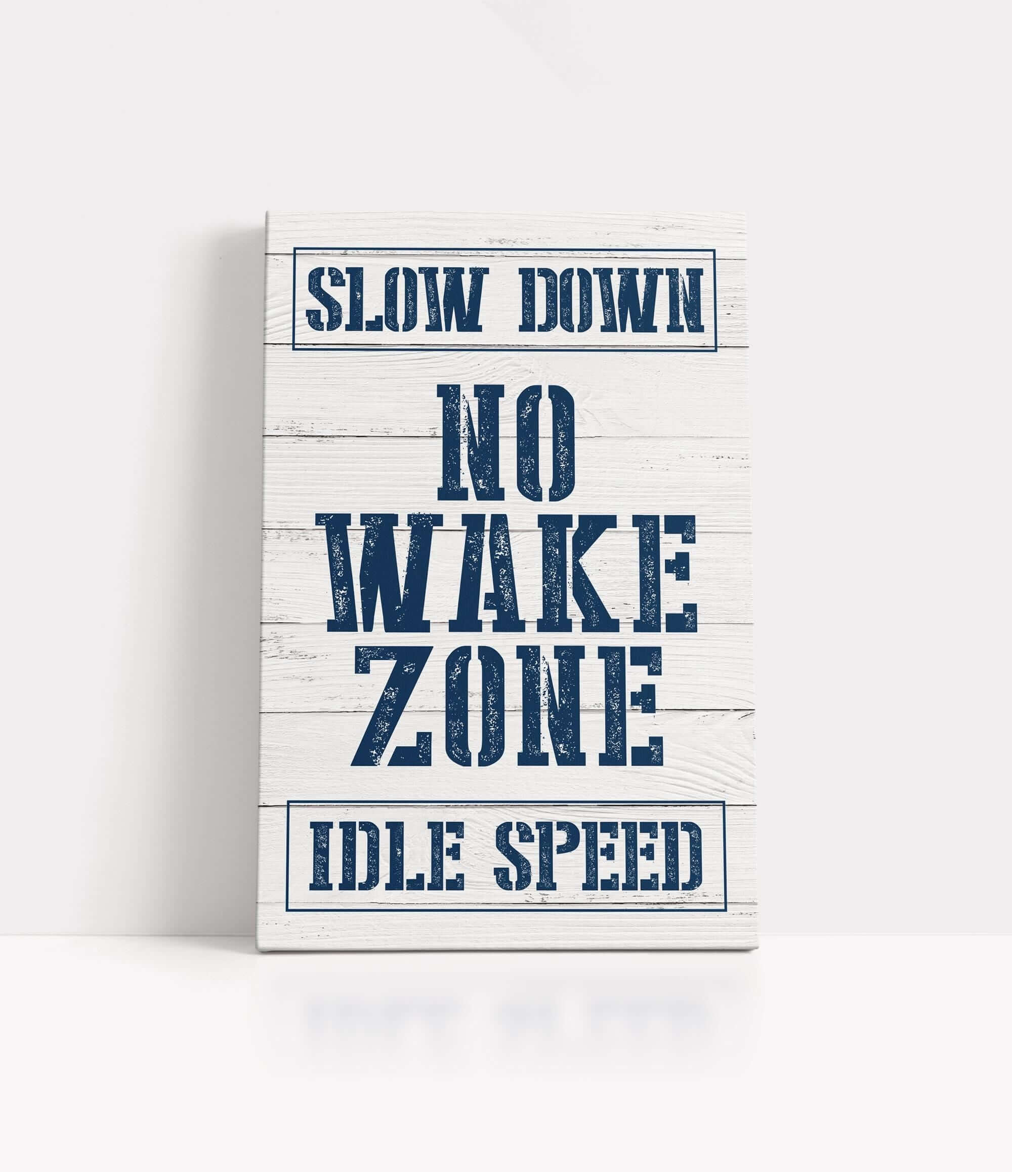 a sign that says slow down no wake zone