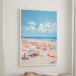 a lively beach scene with numerous people enjoying the sunny day under colorful umbrellas.