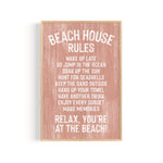 The Beach House Rules Sign, Painted Wood in Coral, displays relaxing beach activities—ideal as coastal wall art or beach house decor for your serene seaside retreat.