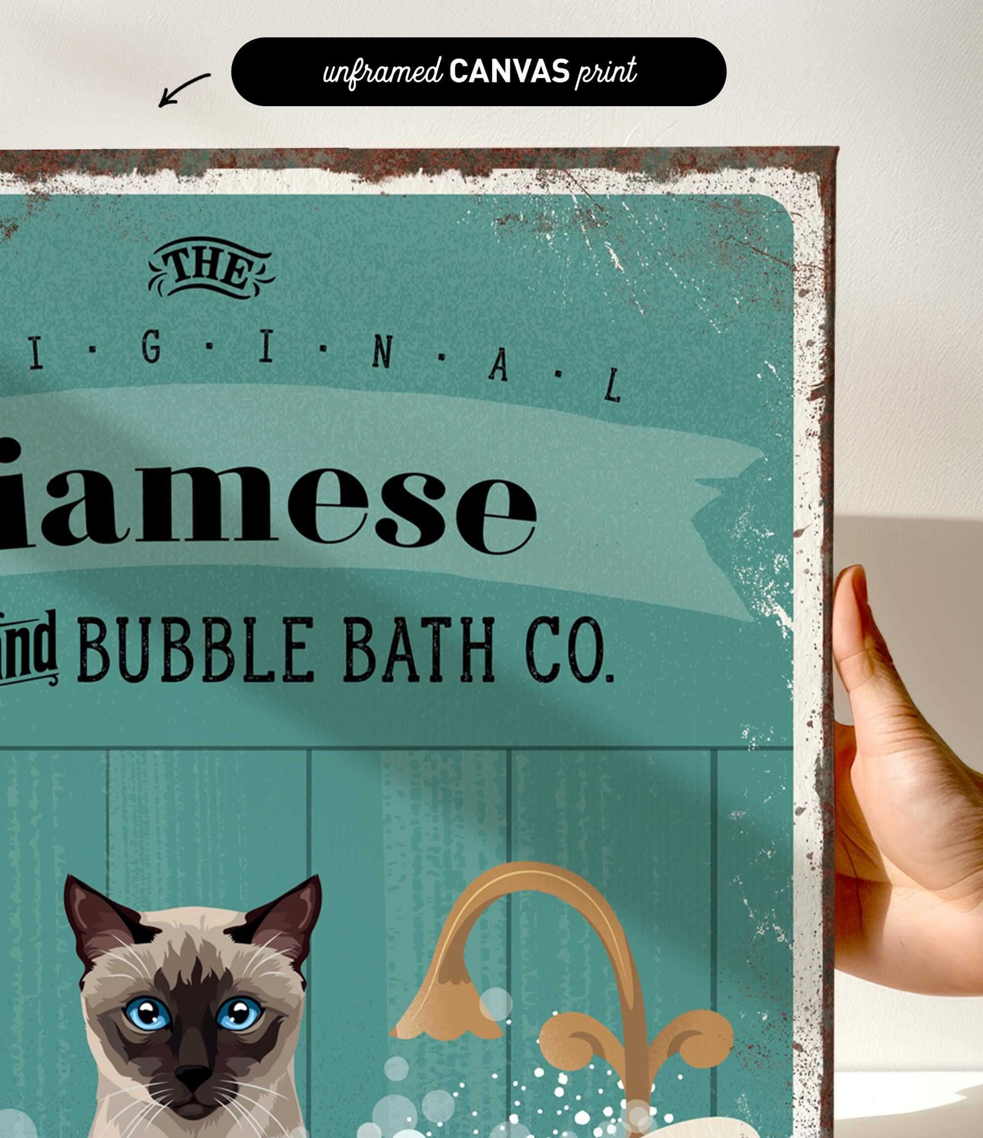 a hand holding a framed print with a cat and a sink, along with some text and graphics.