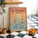 a beach house rule sign on a checkered floor, with a potted plant to the left and a basket of oranges to the right.