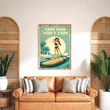 a vintage-style poster of a woman paddleboarding on a lake, with the text "LAKESHORE DON'T CARE" displayed prominently. The poster is hung on a wall above a brown leather couch, which has striped pillows on it. There are also two potted plants in the room, one on each side of the couch.