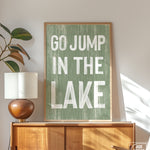 a green sign that says go jump in the lake