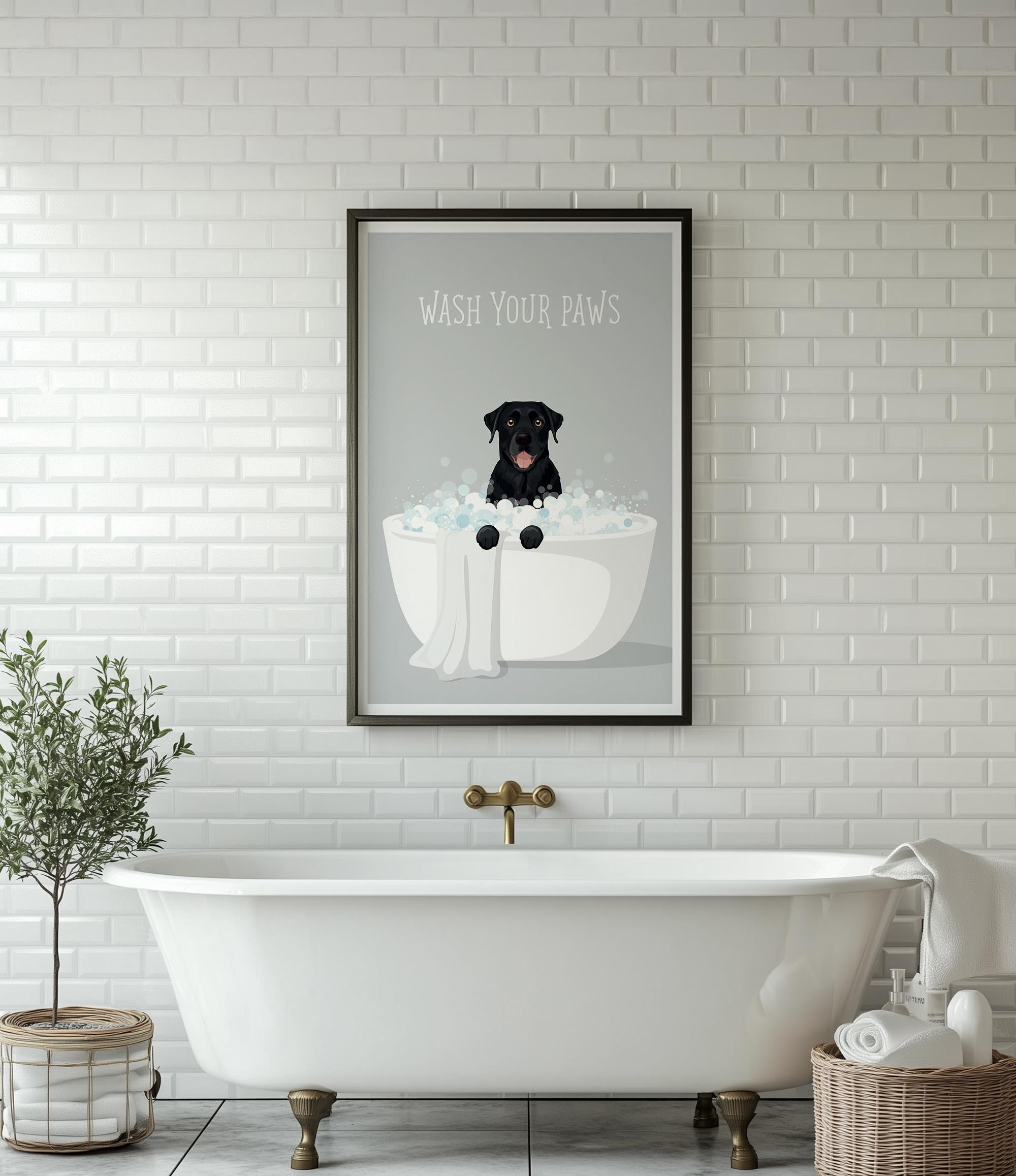 A framed poster with a black dog sitting in a bathtub, surrounded by bubbles, is displayed on a white tiled wall above a white freestanding bathtub.