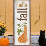 a black cat sitting next to a wooden sign