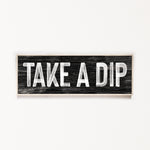 a wooden sign that says take a dip