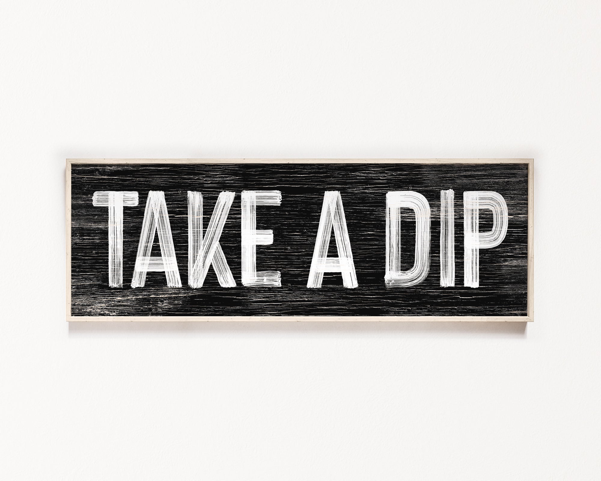 a wooden sign that says take a dip