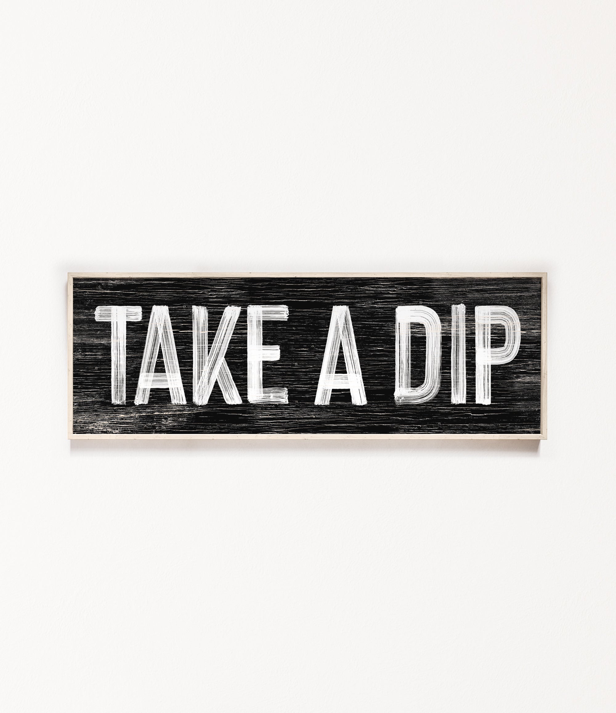 a wooden sign that says take a dip