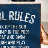 a hand holding a sign that says pool rules