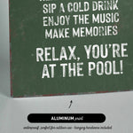 a green sign that says relax you&#39;re at the pool