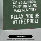 a green sign that says relax you&#39;re at the pool