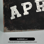 The image is an aluminum print with the text "APR" in white letters on a black background.