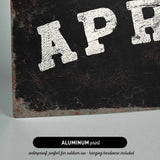 The image is an aluminum print with the text "APR" in white letters on a black background.