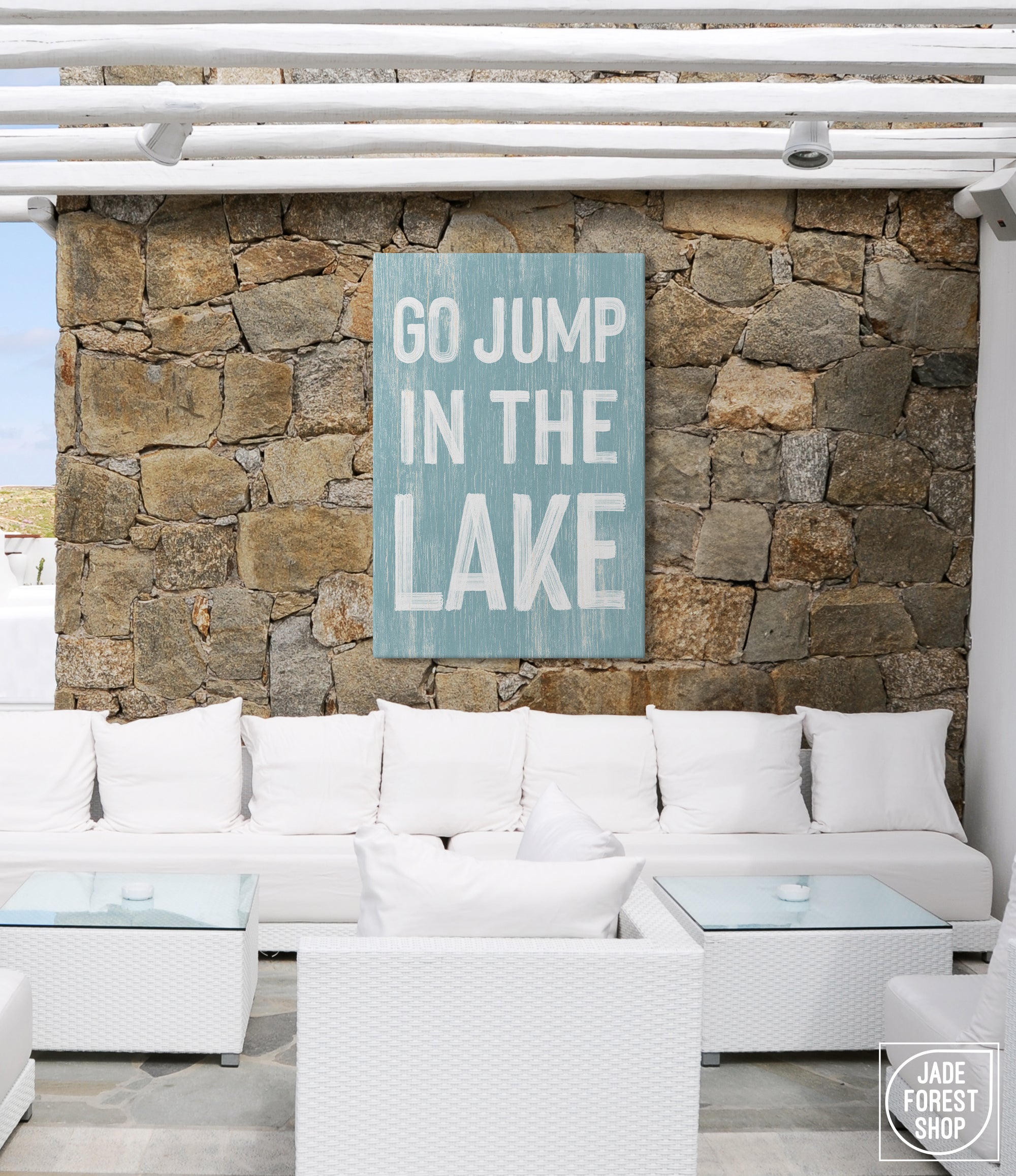 a white couch sitting in front of a stone wall