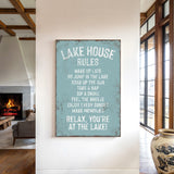 a sign that reads "LAKESHOUSE RULES" hanging on a wall in a room with a fireplace and a vase.