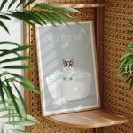 A framed poster with a cat sitting in a bathtub, surrounded by bubbles, with the text "WASH YOUR PAWS" displayed on it.