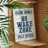 a sign that says slow down no wake zone idle speed