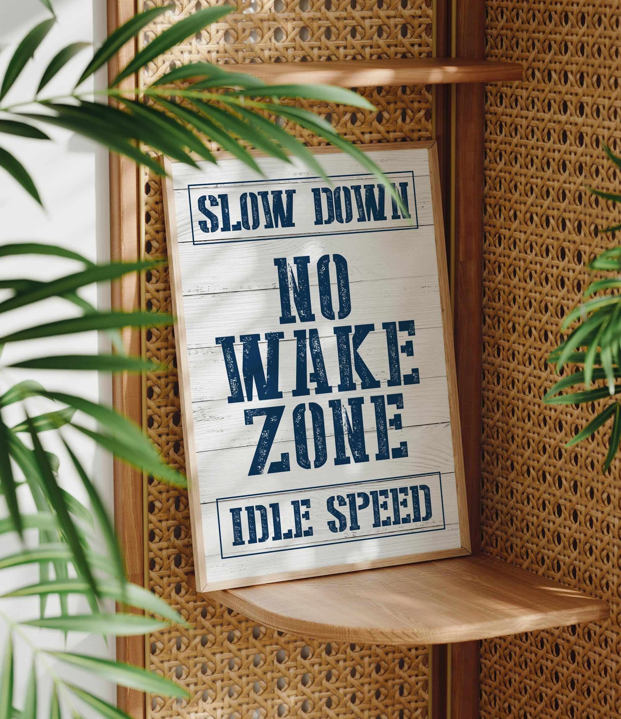 a sign that says slow down no wake zone idle speed