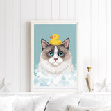 A framed illustration of a cat with a yellow rubber duck on its head, set against a blue background with bubbles.