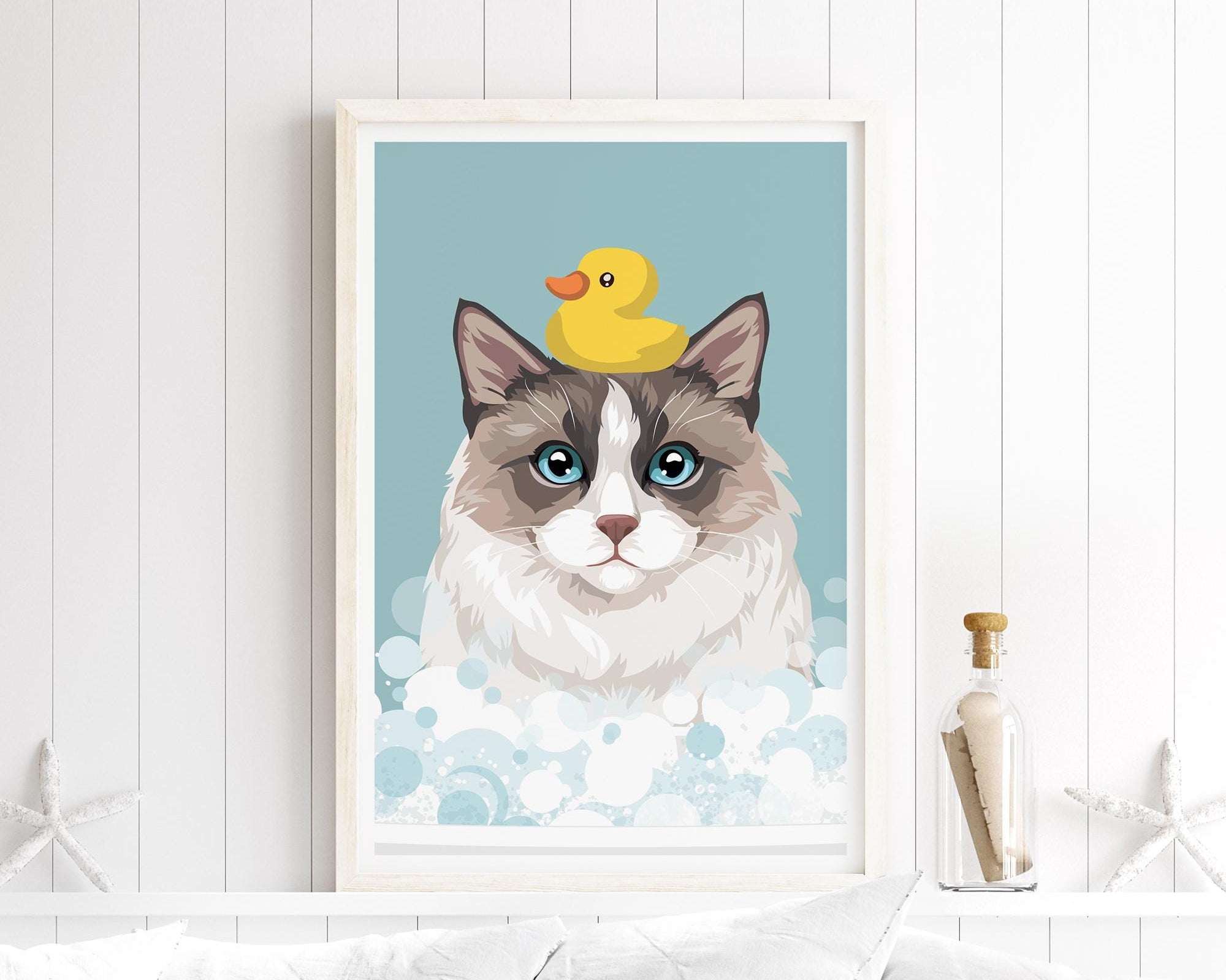 A framed illustration of a cat with a yellow rubber duck on its head, set against a blue background with bubbles.
