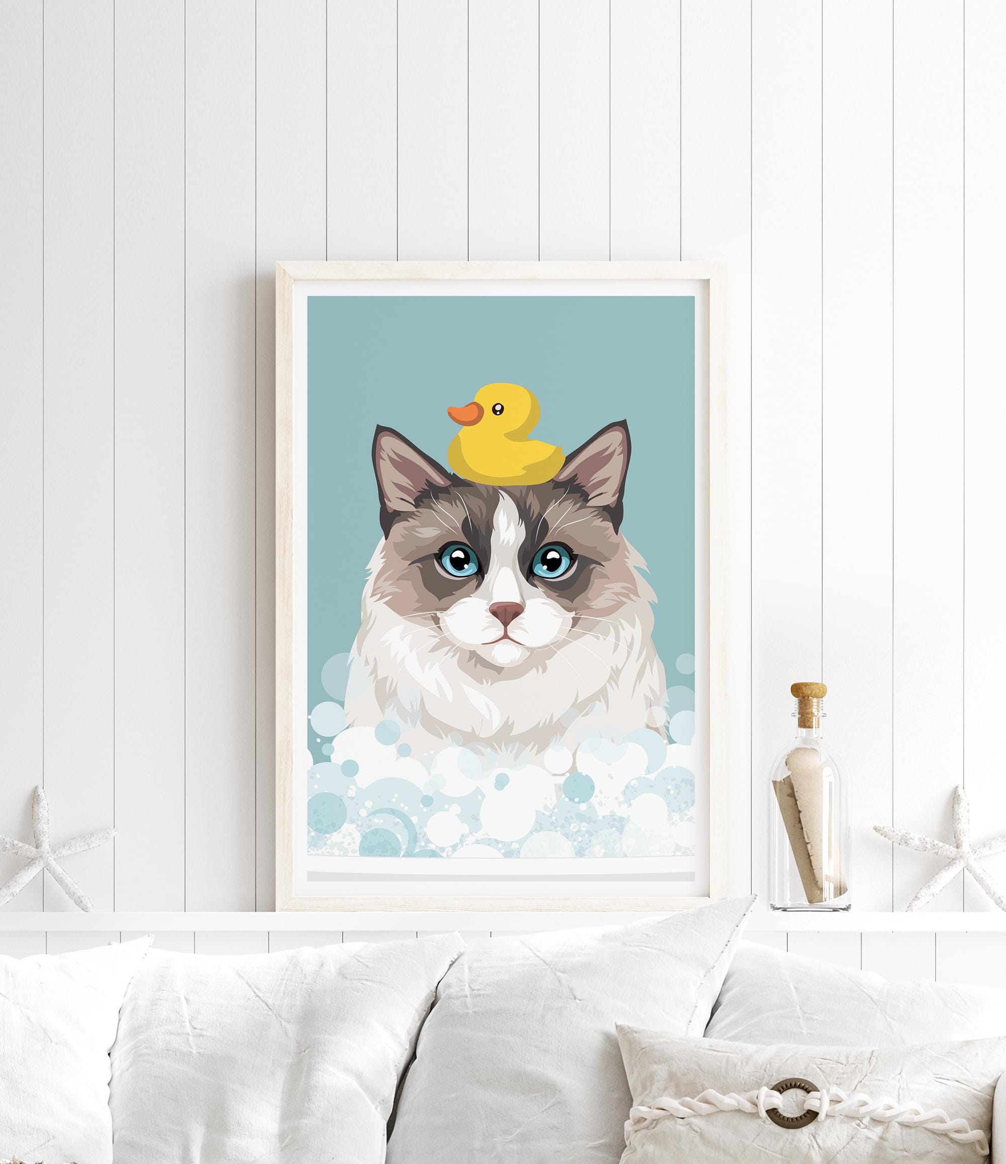 A framed illustration of a cat with a yellow rubber duck on its head, set against a blue background with bubbles.