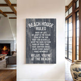a sign on a wall that reads "BEACH HOUSE RULES" and provides a list of beach-related activities and behaviors, such as "WAKE UP LATE", "JUMP IN THE OCEAN", "SOAK UP THE SUN", "HUNT FOR SEAShells", "KEEP THE SAND OUTSIDE", "HANG UP YOUR TOWEL", "HAVEN DRINK", "ENJOY EVERY SUNSET", "MAKE MEMORIES", and "RELAX. YOU'RE AT THE BEACH!".