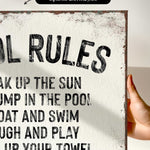 a hand holding a sign that says pool rules