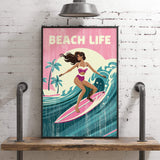 A framed poster of a woman surfing on a wave, with the text "BEACH LIFE" prominently displayed.