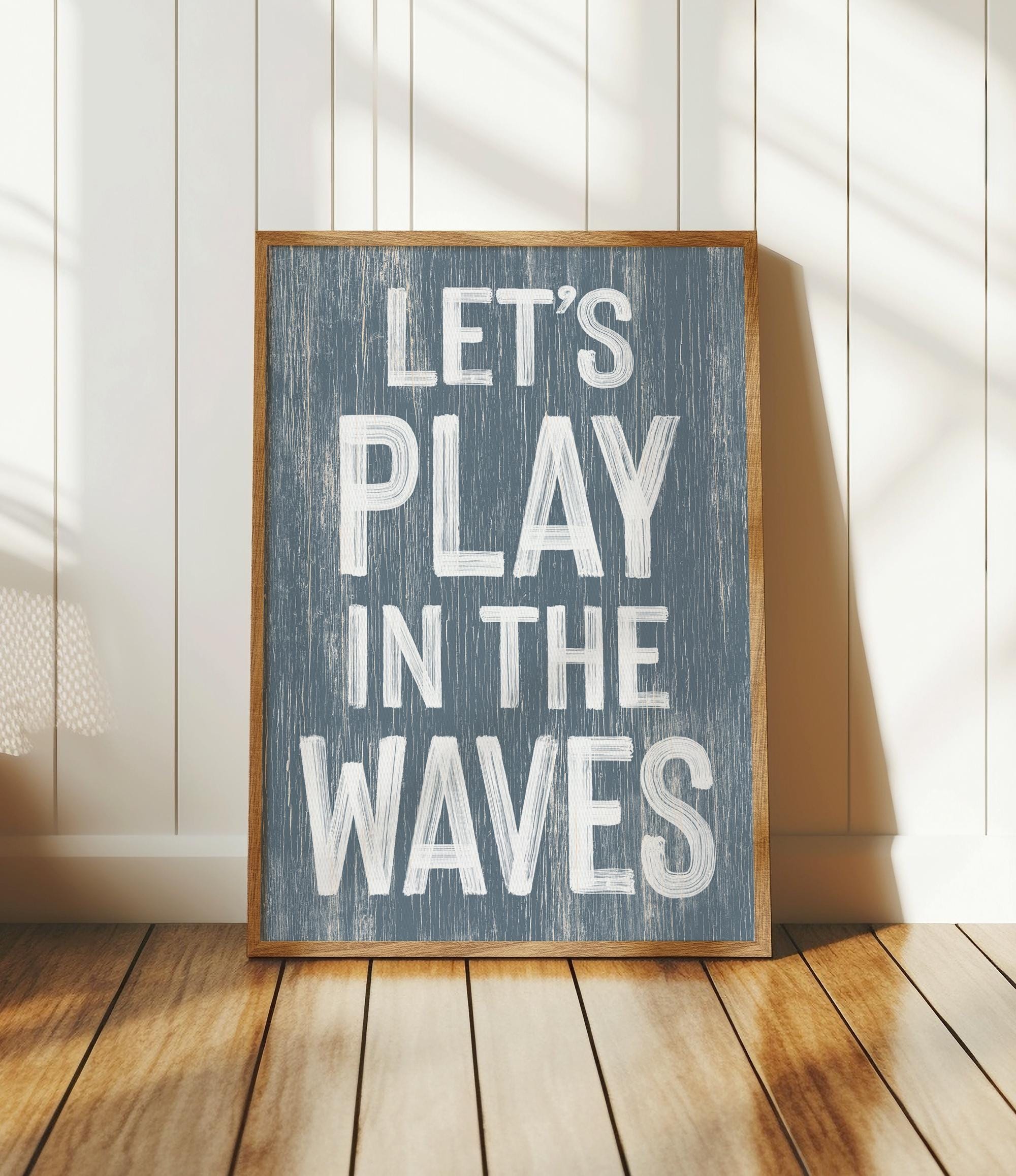 a wooden sign that says let&#39;s play in the waves