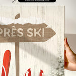 a hand holding up a sign with skis on it
