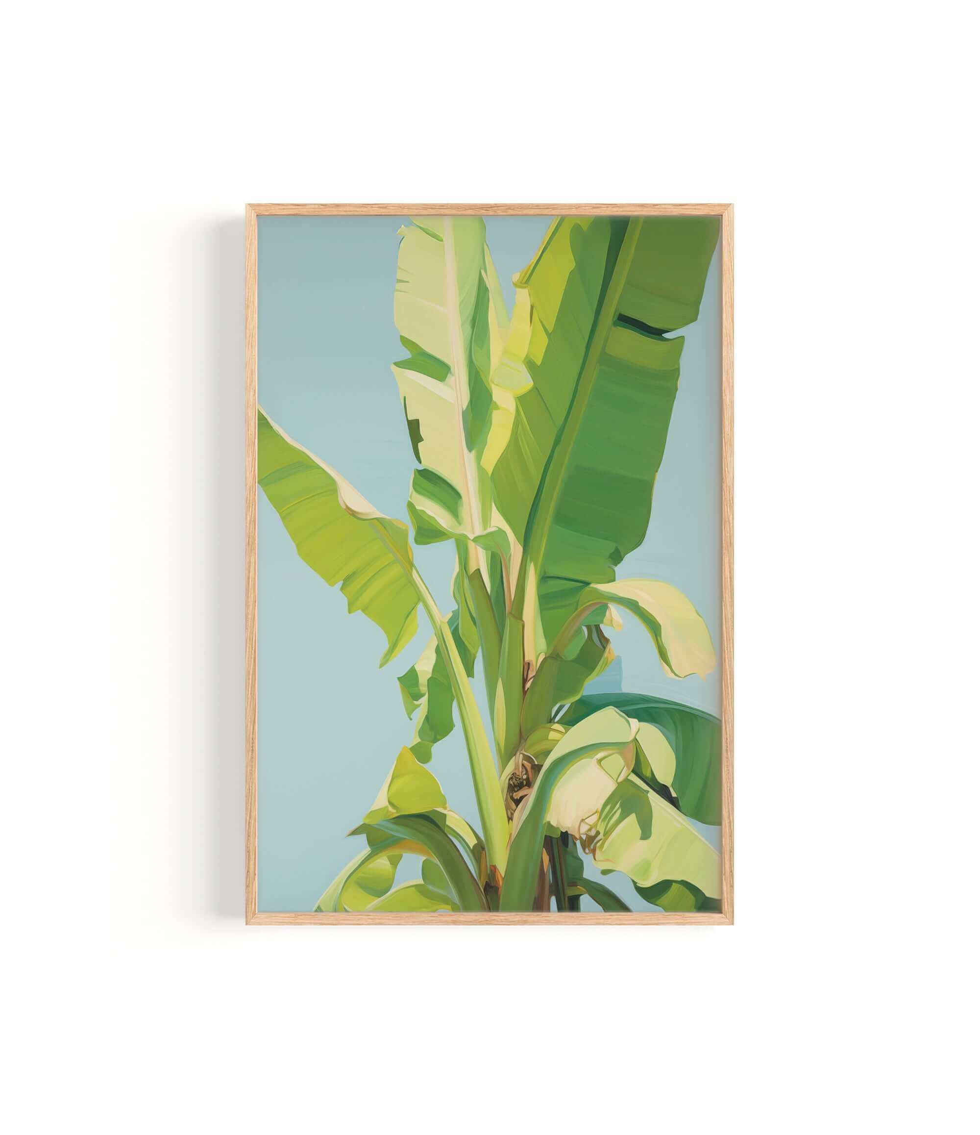 A framed image of a banana tree with large, vibrant green leaves against a blue sky background.