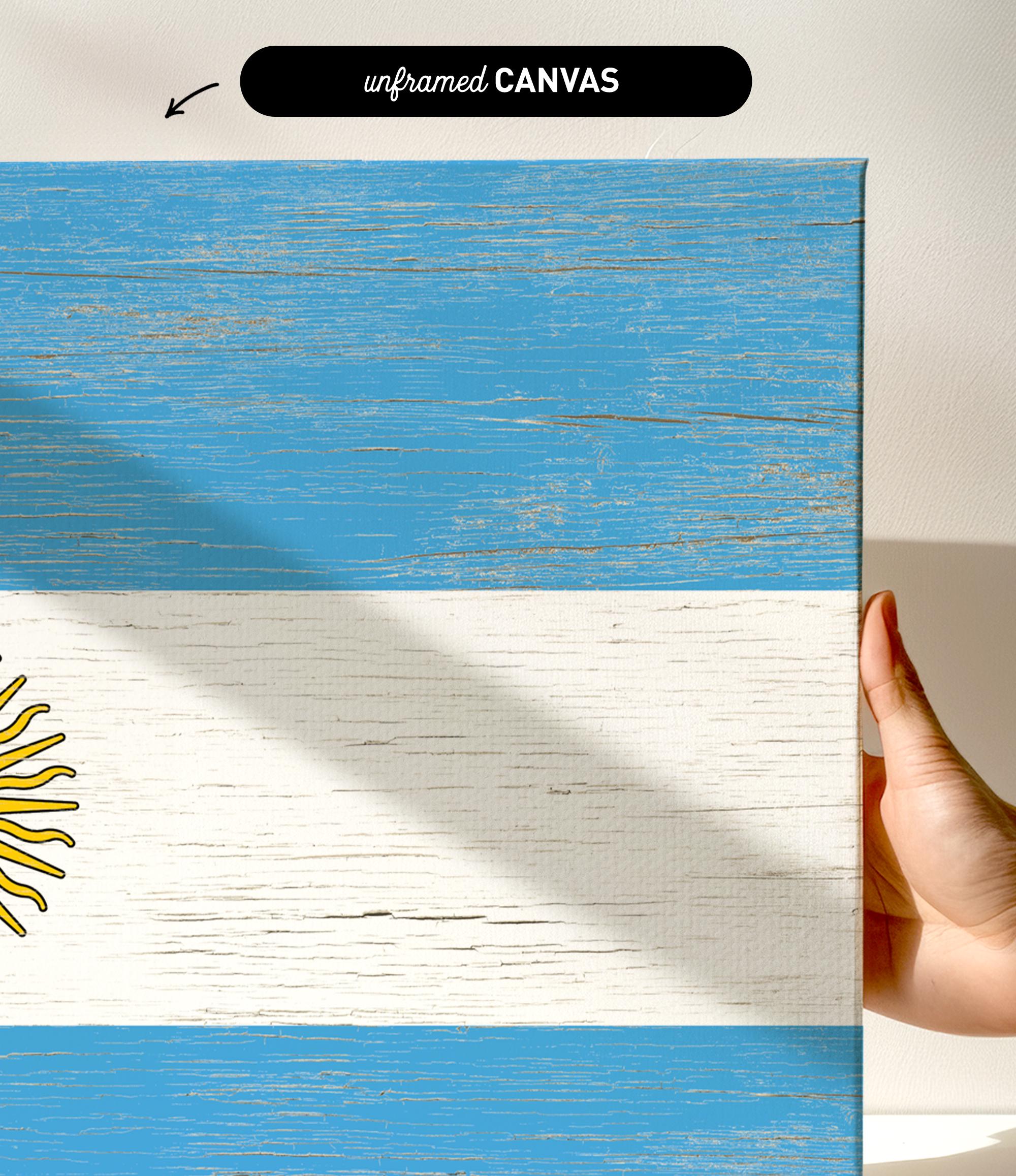 a hand holding a piece of wood with a flag painted on it