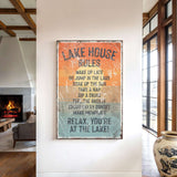 a sign that reads "LAKESHOUSE RULES" hanging on a wall in a room with a fireplace and a large vase.