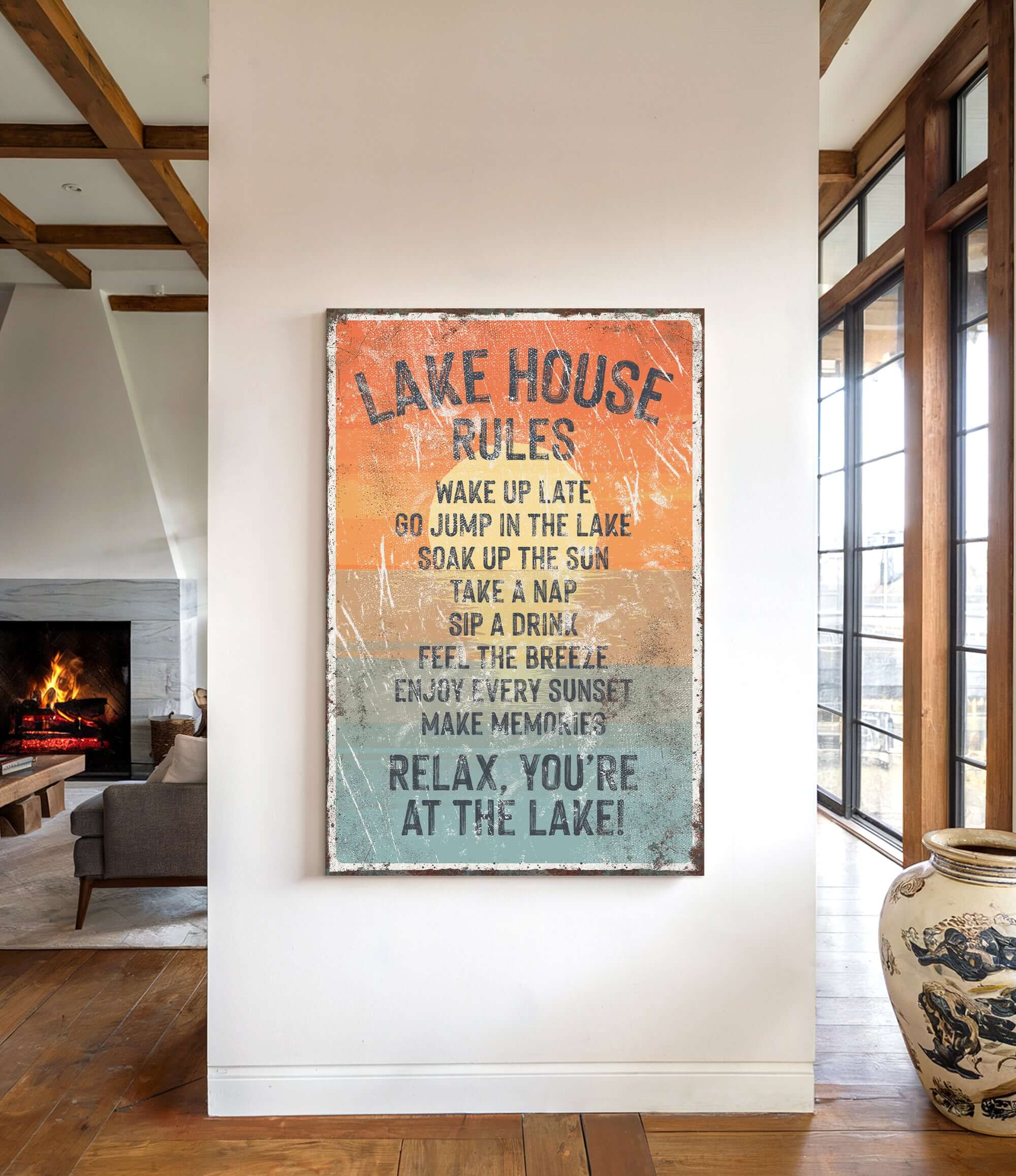 a sign that reads "LAKESHOUSE RULES" hanging on a wall in a room with a fireplace and a large vase.