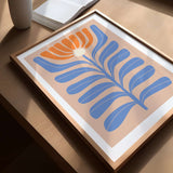 a picture of a blue and orange flower on a table