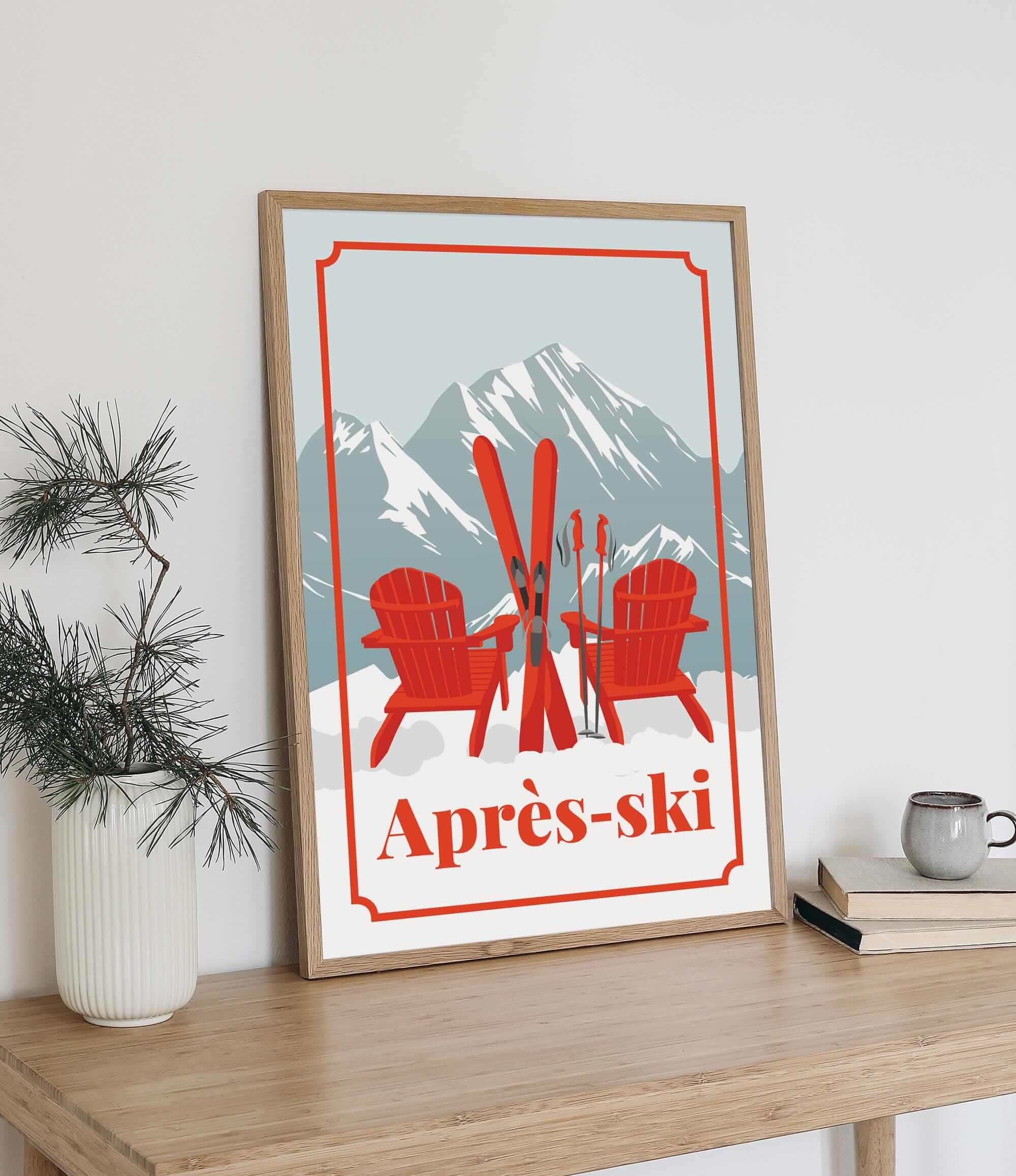 A framed poster with a mountain landscape and two red Adirondack chairs, along with ski equipment, is displayed on a wooden shelf next to a potted plant and a stack of books.