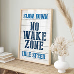 a sign that says slow down, no wake zone idle speed
