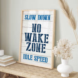 a sign that says slow down, no wake zone idle speed