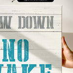 a hand holding a sign that says draw down no wake