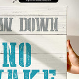 a hand holding a sign that says draw down no wake